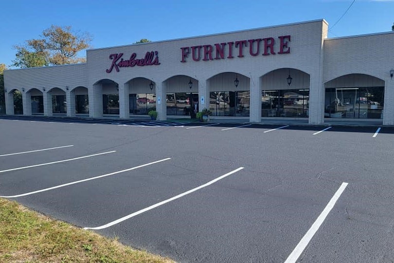 After image of Kimbrell's Furniture parking lot located in Fayetteville, NC with fresh seal coating and striping.
