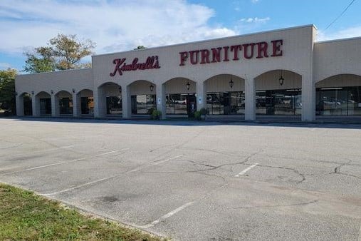 Before sealcoating and striping image of Kimbrell's Furniture parking lot located in Fayetteville, NC.