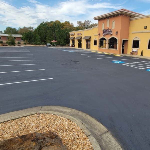 Seal coating and striping after photo of Mi Casita parking lot located at 5584 Camden Rd in Hope Mills, NC.