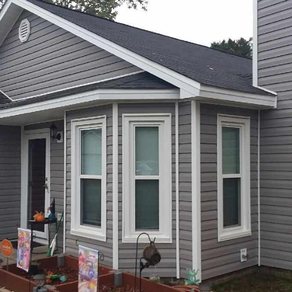 New gray vinyl siding with white trim installed on house located in Fayetteville, NC.