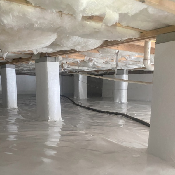Fayetteville, NC crawlspace with newly installed 20 Mil Vapor Barrier on ground and piers with R-19 Insulation installed.