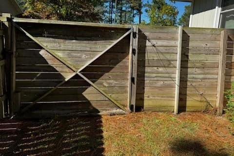 Before photo of old damaged wood privacy fence gate in Fayetteville, NC.