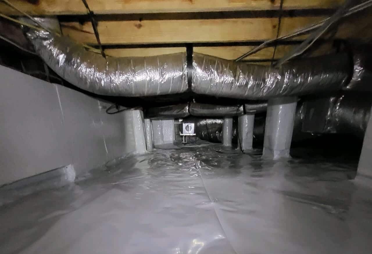 After photo of Fayetteville, NC crawlspace with new 20 mil vapor barrier on ground and piers and foundation wall sealed with insulation board.